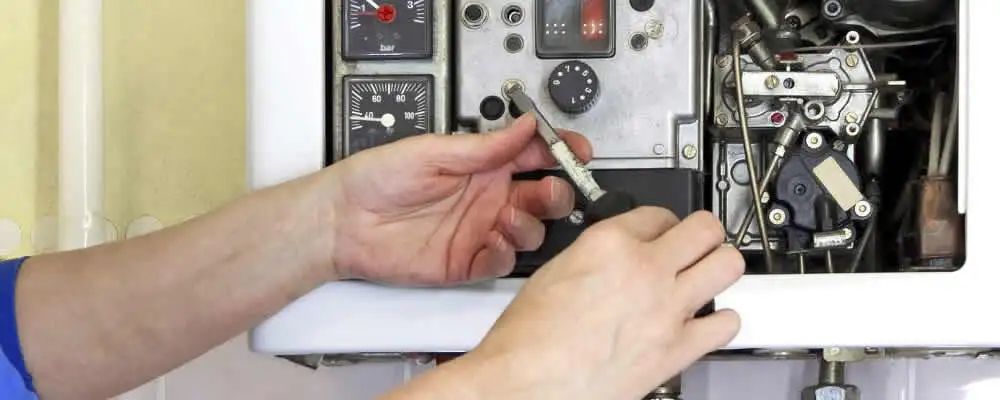 Heating repair technician adjusting boiler controls and components in Champaign, IL